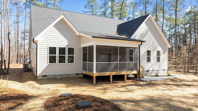 back of property featuring roof with shingles, a sunroom, and crawl space