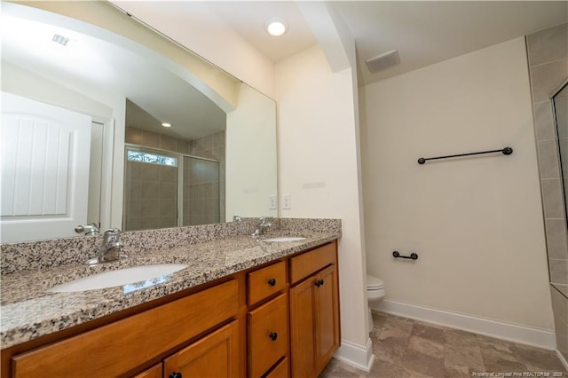 full bath featuring a sink, baseboards, a shower stall, and double vanity