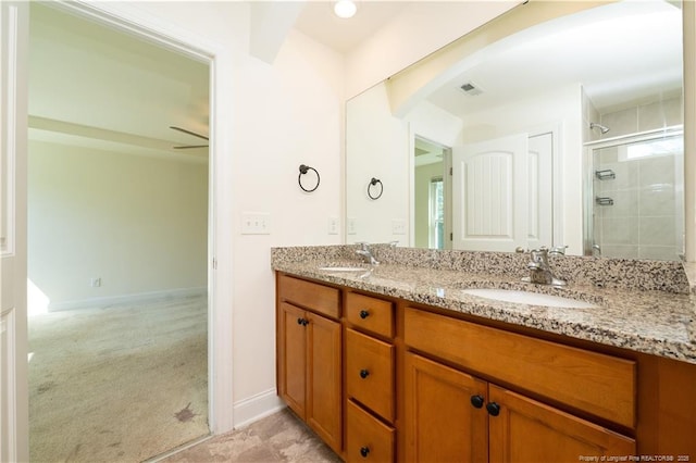 bathroom with double vanity, visible vents, a shower stall, and a sink