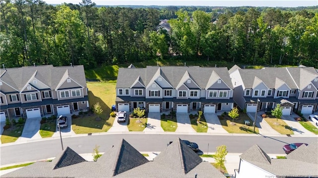 birds eye view of property with a view of trees and a residential view