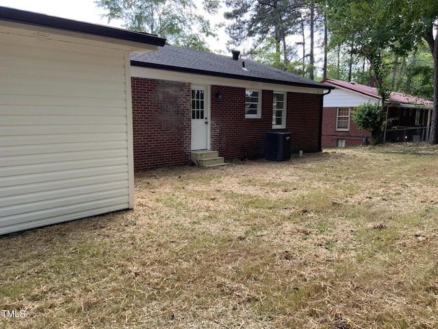502 Burton St, Fuquay Varina, NC 27526 - back of house featuring entry steps, brick siding, and a lawn
