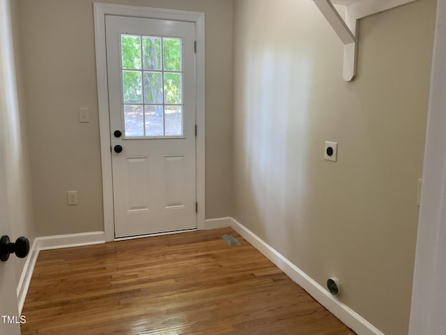 502 Burton St, Fuquay Varina, NC 27526 - doorway to outside with baseboards and light wood-style flooring