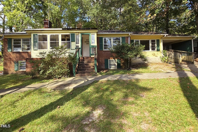 502 Burton St, Fuquay Varina, NC 27526 - split level home featuring a front lawn, brick siding, a chimney, and a carport