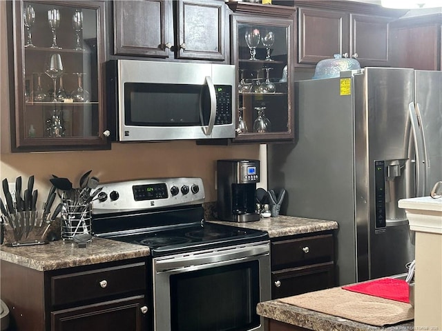 kitchen with glass insert cabinets and stainless steel appliances