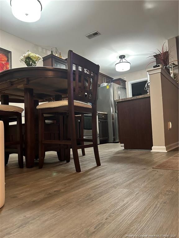 dining room featuring visible vents and wood finished floors