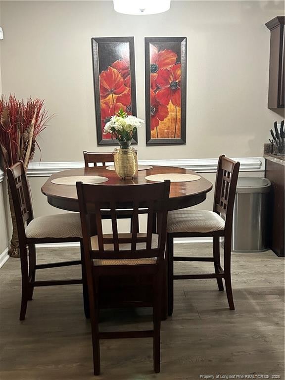 dining room featuring baseboards and wood finished floors