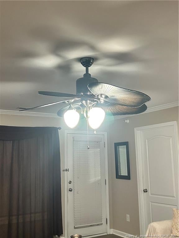 interior space with crown molding and baseboards
