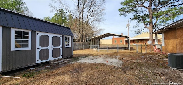 511 W Northrop St, Saint Pauls, NC 28384 - view of yard featuring an outdoor structure, a detached carport, cooling unit, a fenced backyard, and a storage unit