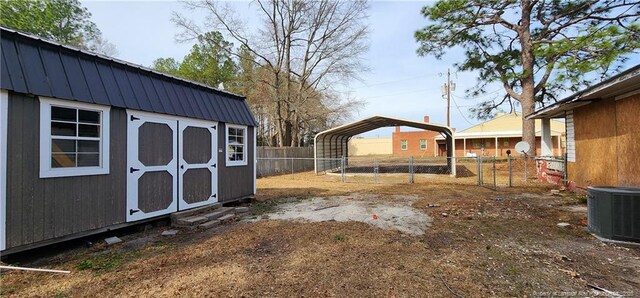 511 W Northrop St, Saint Pauls, NC 28384 - view of yard featuring an outdoor structure, a detached carport, cooling unit, a fenced backyard, and a storage unit