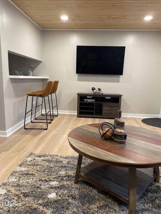living room featuring baseboards, recessed lighting, wood ceiling, and wood finished floors