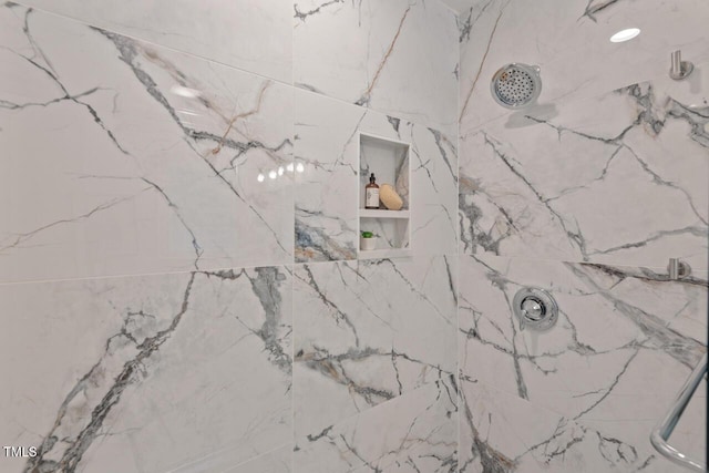 room details featuring a marble finish shower