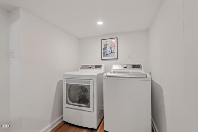 laundry area with laundry area, recessed lighting, independent washer and dryer, and wood finished floors