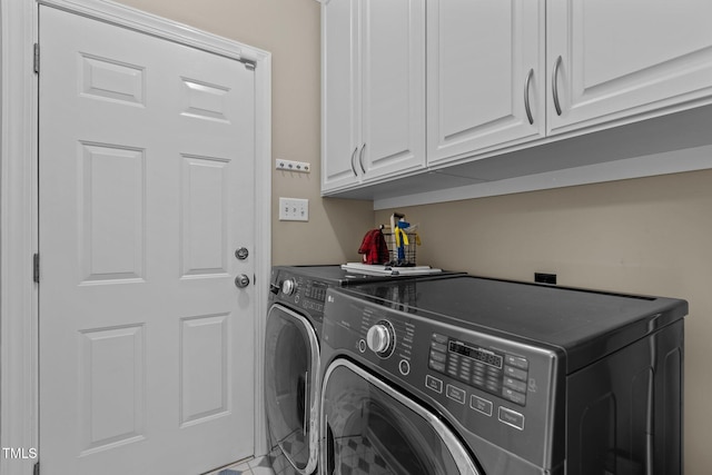 laundry area featuring washer and dryer and cabinet space