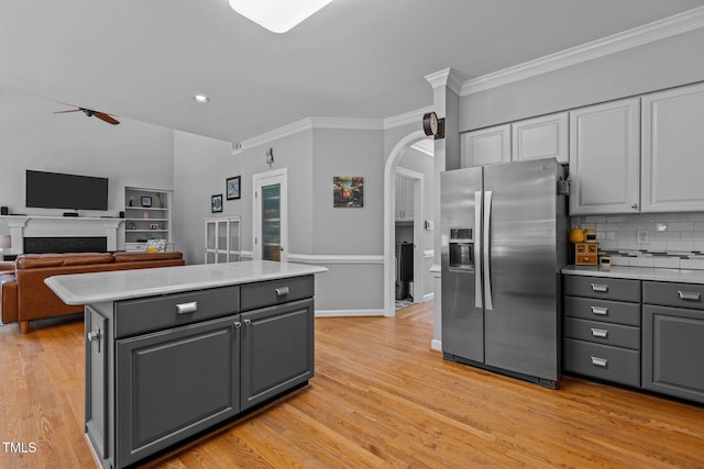 kitchen featuring ceiling fan, ornamental molding, gray cabinetry, and stainless steel fridge with ice dispenser