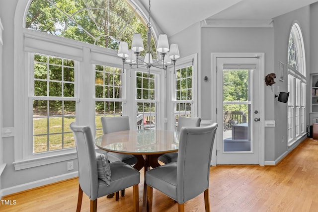 sunroom featuring an inviting chandelier and french doors