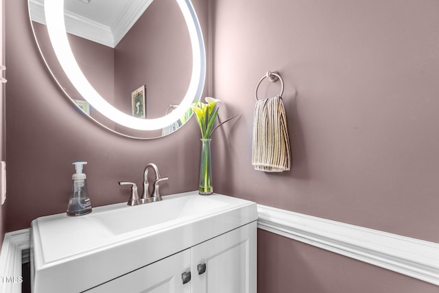 bathroom featuring crown molding and vanity