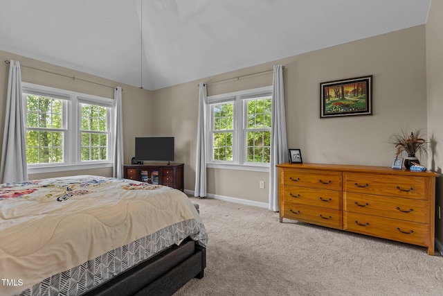 carpeted bedroom with multiple windows, baseboards, and lofted ceiling