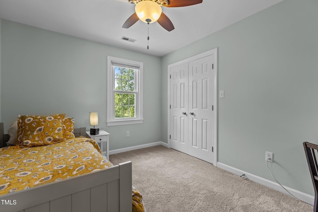 carpeted bedroom with ceiling fan, baseboards, a closet, and visible vents
