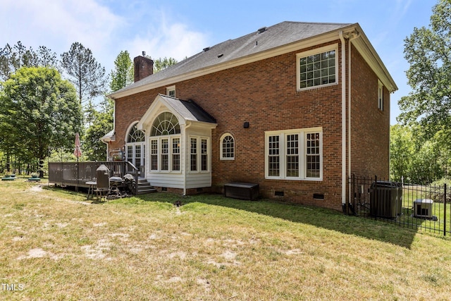 rear view of house with crawl space, a chimney, fence, a deck, and brick siding