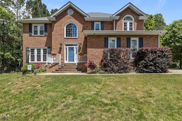 view of front of house with brick siding and a front yard