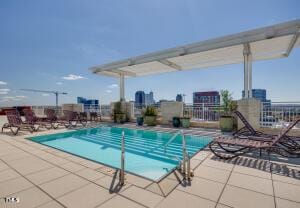 community pool featuring fence and a patio area