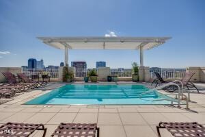 pool with fence and a patio area
