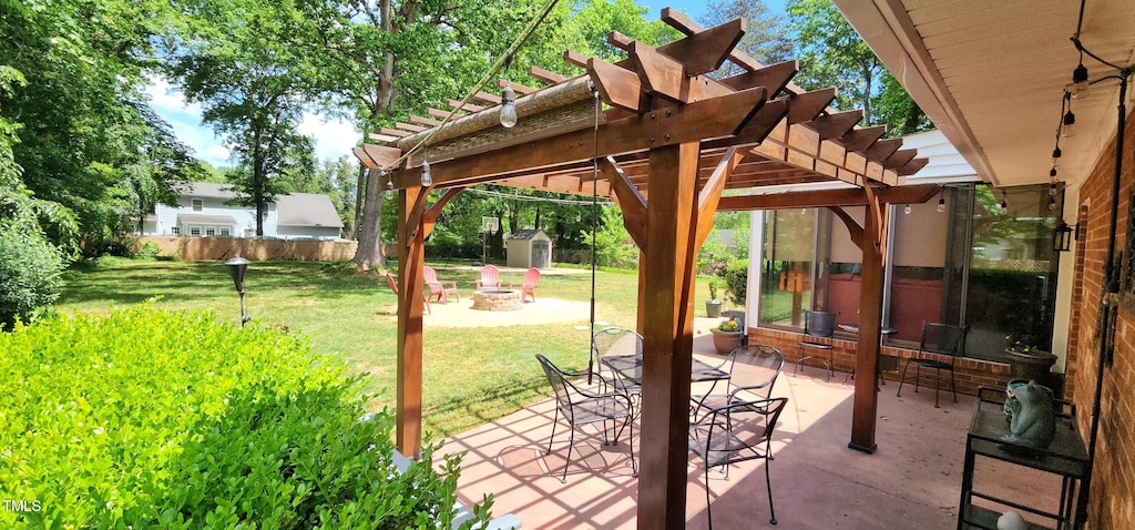 view of patio with fence, a pergola, a shed, an outdoor structure, and a fire pit