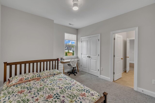 bedroom featuring baseboards, carpet flooring, visible vents, and a closet