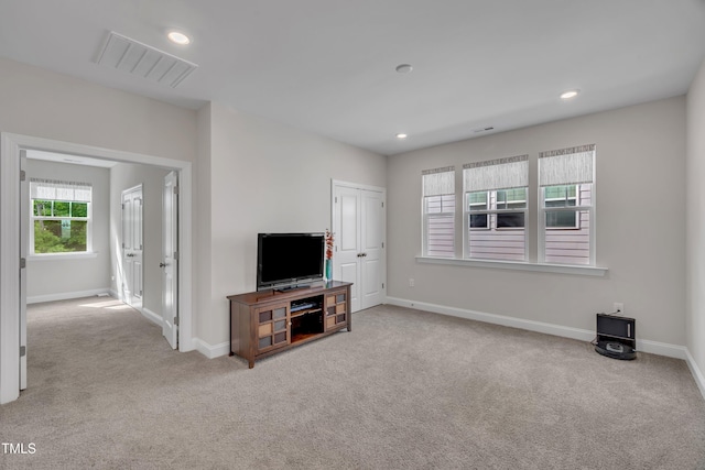 unfurnished living room with visible vents, carpet flooring, and baseboards