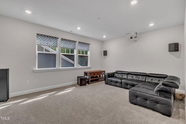 living area featuring carpet floors, baseboards, and recessed lighting
