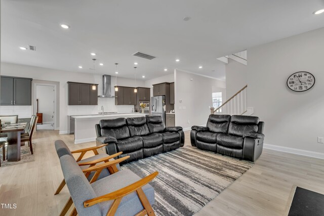 living room featuring visible vents, recessed lighting, and light wood-style flooring