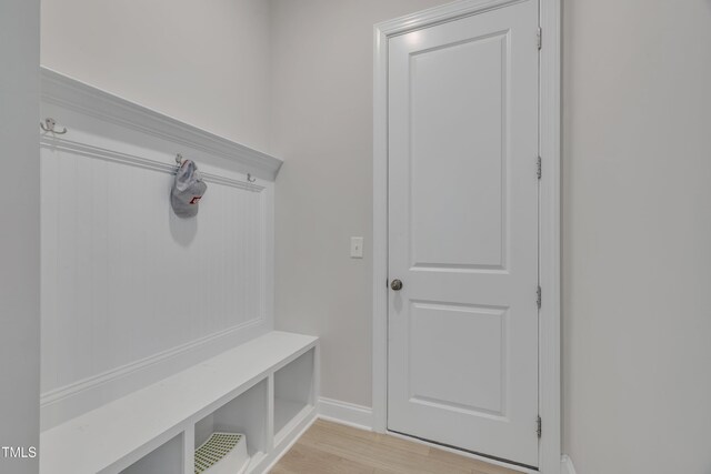 mudroom featuring baseboards and light wood-style flooring