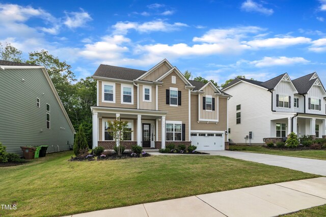 view of front of property featuring a front lawn, covered porch, board and batten siding, concrete driveway, and an attached garage