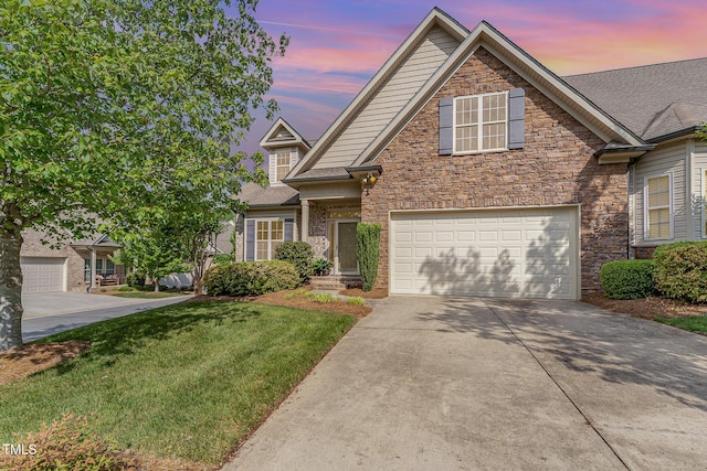 106 Jordan Creek Dr, Jamestown, NC 27282 - traditional-style home with an attached garage, a yard, stone siding, and concrete driveway