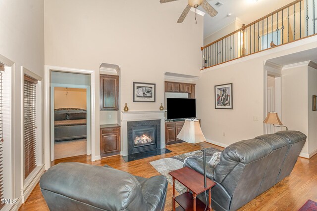 106 Jordan Creek Dr, Jamestown, NC 27282 - living room with a ceiling fan, a high ceiling, a fireplace with flush hearth, and baseboards