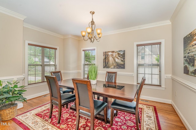 106 Jordan Creek Dr, Jamestown, NC 27282 - dining space with crown molding, visible vents, light wood-style flooring, and a chandelier