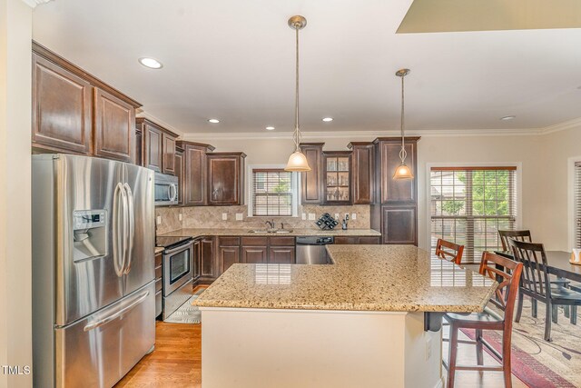106 Jordan Creek Dr, Jamestown, NC 27282 - kitchen featuring a healthy amount of sunlight, appliances with stainless steel finishes, light wood-style flooring, and a sink