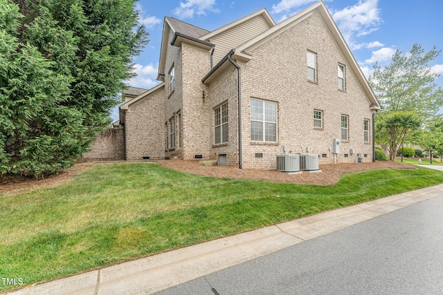 106 Jordan Creek Dr, Jamestown, NC 27282 - view of home's exterior featuring central AC unit, a yard, crawl space, and brick siding