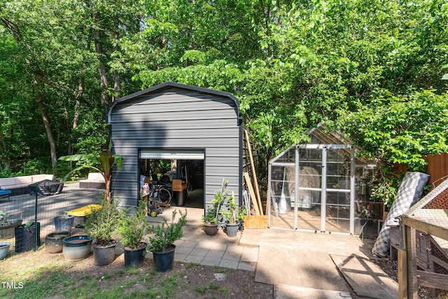 view of greenhouse featuring fence