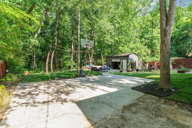exterior space featuring fence and an outbuilding