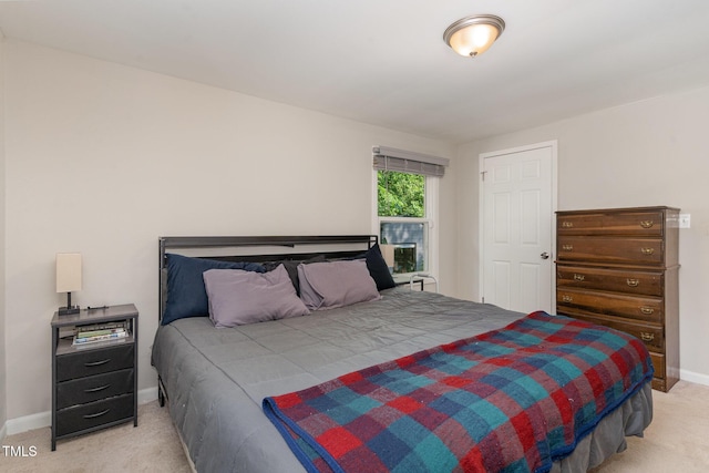 bedroom featuring baseboards and light colored carpet