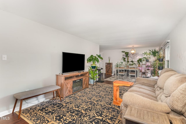 living area featuring baseboards and wood finished floors