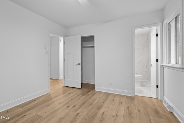 unfurnished bedroom featuring a closet, visible vents, multiple windows, and light wood-type flooring