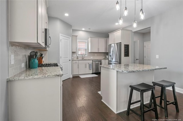 5113 Boxcut Ln, Hope Mills, NC 28348 - kitchen featuring stainless steel appliances, a sink, tasteful backsplash, a center island, and recessed lighting