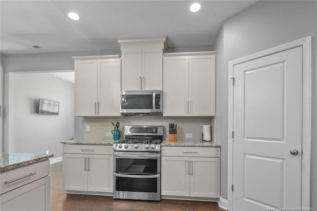 5113 Boxcut Ln, Hope Mills, NC 28348 - kitchen with stainless steel appliances, white cabinets, dark wood-type flooring, recessed lighting, and tasteful backsplash