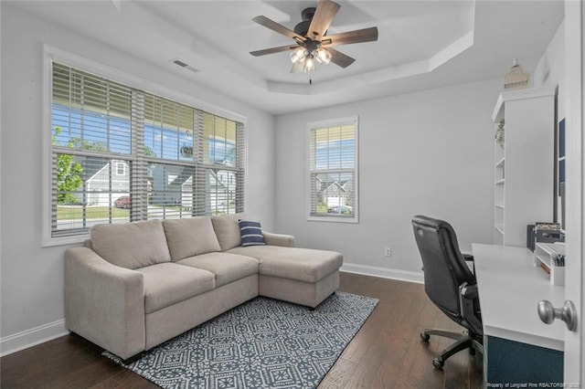 5113 Boxcut Ln, Hope Mills, NC 28348 - home office featuring a tray ceiling, a ceiling fan, and dark wood-style floors