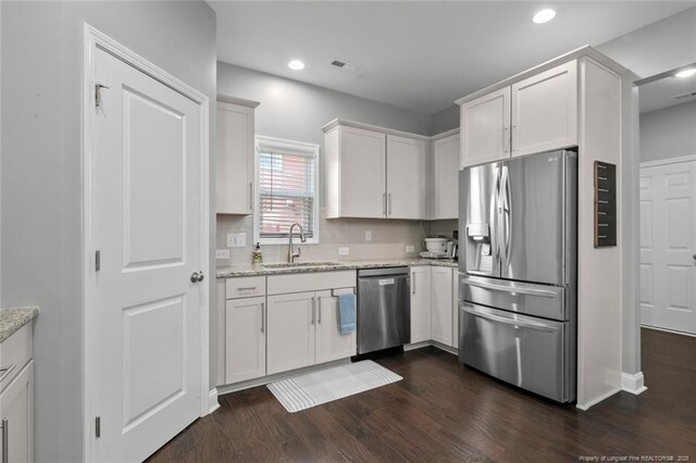 5113 Boxcut Ln, Hope Mills, NC 28348 - kitchen with stainless steel appliances, dark wood-type flooring, light stone countertops, white cabinets, and recessed lighting