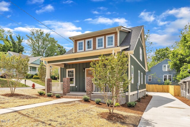 801 N Elm St, Durham, NC 27701 - view of front of house with fence, roof with shingles, board and batten siding, concrete driveway, and a porch