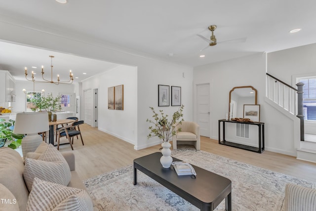 801 N Elm St, Durham, NC 27701 - living area with stairs, baseboards, ceiling fan with notable chandelier, and light wood-type flooring