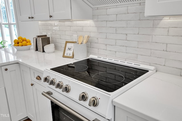 801 N Elm St, Durham, NC 27701 - kitchen featuring decorative backsplash, extractor fan, white cabinets, and white range with electric cooktop